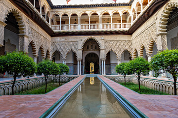 Fototapeta premium Beautiful formal public garden inside Alcazar Seville palace in summertime in Andalusia