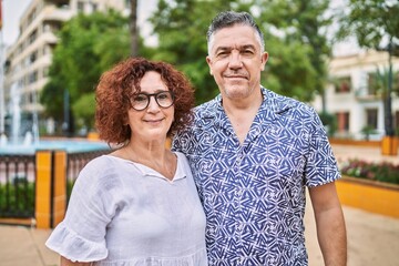 Naklejka premium Middle age hispanic couple together outdoors on summer day