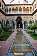 Fototapeta premium Beautiful formal public garden inside Alcazar Seville palace in summertime in Andalusia