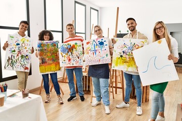 Fototapeta premium Group of people smiling happy canvas with draw standing at art studio.