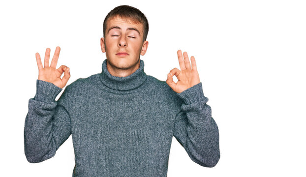 Young blond man wearing casual clothes relax and smiling with eyes closed doing meditation gesture with fingers. yoga concept.
