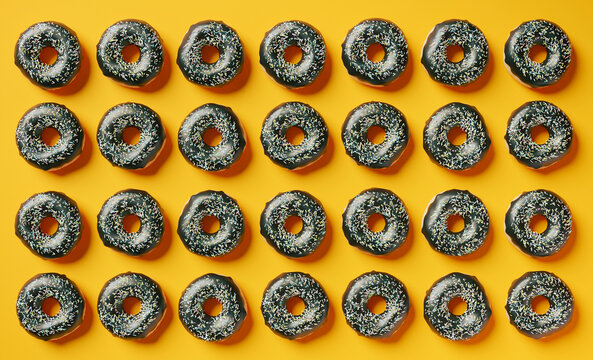 Chocolate donuts on vibrant orange background, 3d rendered pattern. Food background, vibrant pattern of doughnuts, copy space