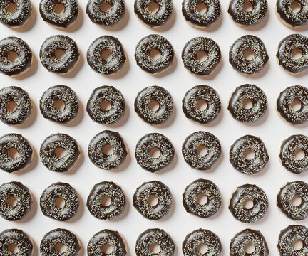 Chocolate donuts on isolated white background, 3d rendered pattern. Food background, vibrant pattern of doughnuts, copy space