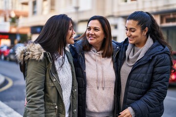 Three woman mother and daughters standing together at street
