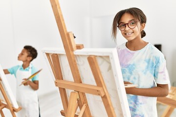 Brother and sister smiling confident drawing at art studio