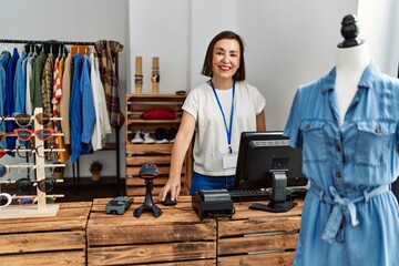 Middle age hispanic woman working as shopping assistant at retail shop