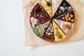 Several cakes with fruits and nuts are symmetrically laid out on parchment paper. Food delivery. Homemade baking.