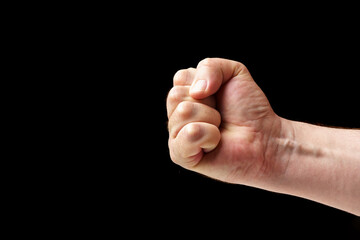 Fist of a man close-up on a black background