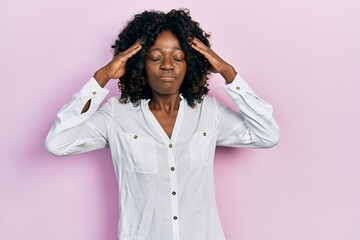 Young african american woman wearing casual clothes with hand on head, headache because stress. suffering migraine.