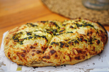 Baked goods at a bakery or market stall on farmer market. Fresh baked ciabatta bread with different toppings. Street food on weekly market.