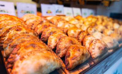 freshly baked empanadas with different fillings for sale