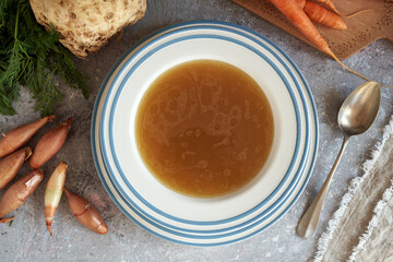 A plate of beef bone broth with fresh vegetables