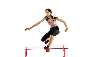Young caucasian woman running, jumping isolated on white studio background. One female runner or jogger. Sport, track-and-field athletics, competition concept