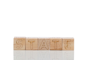 Wooden cubes with letters state on a white background