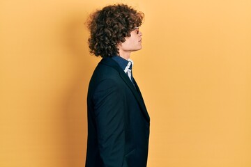 Obraz premium Handsome young man wearing business jacket and glasses looking to side, relax profile pose with natural face with confident smile.