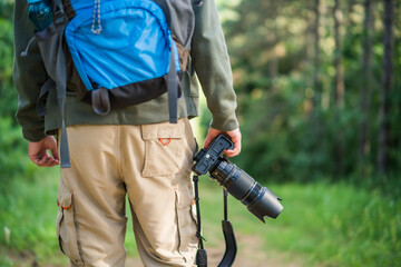 Image of man photographing  while hiking in the nature.