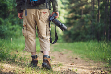 Image of man photographing  while hiking in the nature.