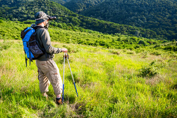 Fototapeta na wymiar Image of man hiking and using binoculars.
