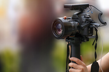 dslr camera and microphone receiver used for video shooting on the street