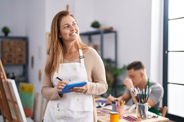 Man and woman artists drawing on notebook using touchpad at art studio