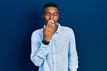 Young african american man wearing casual clothes bored yawning tired covering mouth with hand. restless and sleepiness.