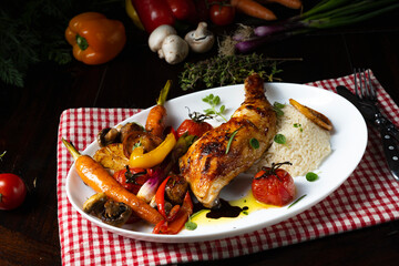 Rustic fried chicken legs with assorted vegetables and rice
