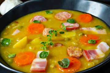 Hearty rustic pea soup with bacon and sausage