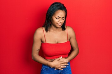 Young african american girl wearing casual style with sleeveless shirt with hand on stomach because...