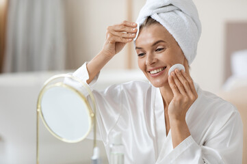 Good-looking adult lady using peeling pads, closeup