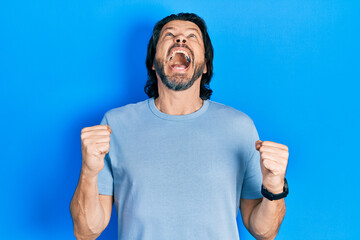 Middle age caucasian man wearing casual clothes angry and mad screaming frustrated and furious,...