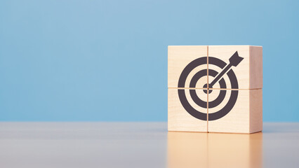 Wooden blocks with target icon on wooden table blue background copy space. The concept of strategy,...