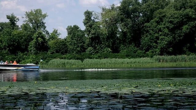 people go boating on the river in summer