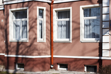 modern plastic windows in the wall of the house
