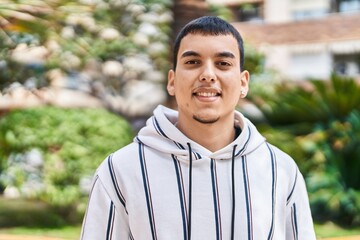 Young man smiling confident standing at park