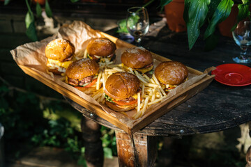 Tasty grilled home made burger cooking with beef, tomato, cheese, cucumber and lettuce