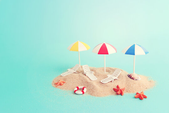holidays image of tropical sea and beach chairs under umbrellas. Summer travel and vacation concept