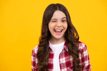 Happy teenager, positive and smiling emotions of teen girl. Teenager child girl close one eye, winks and smiling. Human facial emotions concept. Funny winking face gesture.