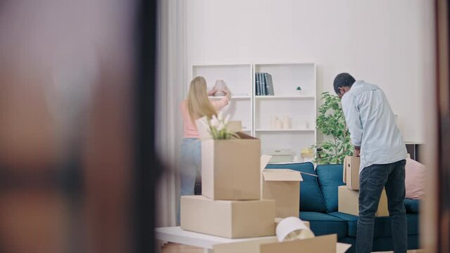 Multiethnic couple unpacking their stuff in a new apartment, new beginnings