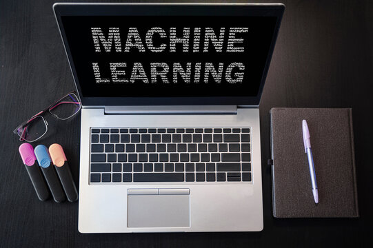 Top view of laptop with text machine learning. Machine learning inscription on laptop screen.