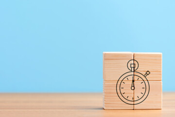 Wooden cubes on blue background with icon of time management stopwatch performance time time speed,...