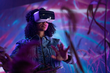 Metaverse digital cyber world technology, woman with virtual reality VR goggles playing augmented...