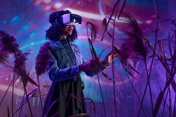 Metaverse digital cyber world technology, woman with virtual reality VR goggles playing augmented reality game, futuristic lifestyle