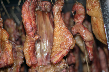 Drying meat in the smokehouse to smoke. 