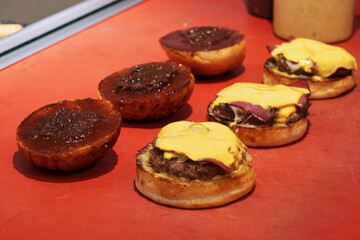Burgers, hamburgers or cheeseburgers on the restaurant kitchen counter ready to be served.