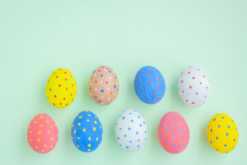 Colorful eggs on green background
