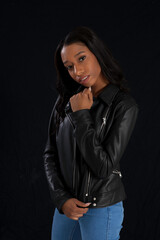 Beautiful woman in a black leather jacket, looking pensive