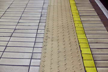Tactile tiles for the blind. Panels for the blind laid on asphalt. Guide tape for the disabled.