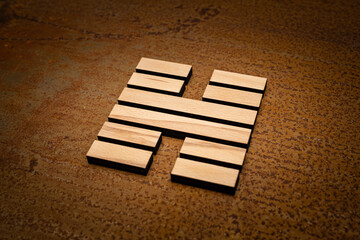 wooden Gene Key 62 i ging hexagram on rusty metal background human design
