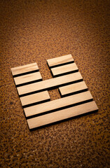wooden Gene Key 54 i ging hexagram on rusty metal background human design