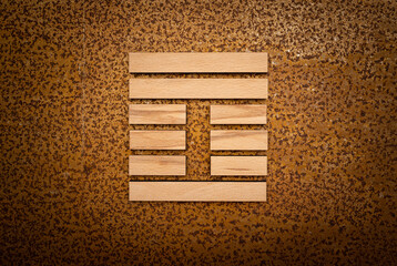 wooden Gene Key 42 i ging hexagram on rusty metal background human design